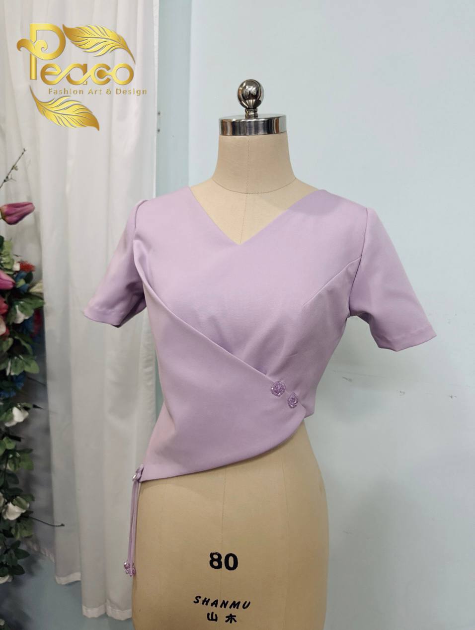 Asymmetric Wrap Blouse with Tassel Detail